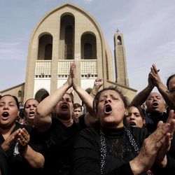 Egyptian Christians chant anti-Muslim Brotherhood slogans following a funeral service at the Saint Mark Coptic cathedral in Cairo, Egypt, Sunday, April 7, 2013. Several Egyptians including 4 Christians and a Muslim were killed in sectarian clashes before dawn in Qalubiya, just outside of Cairo on Saturday, April 6, 2013. 