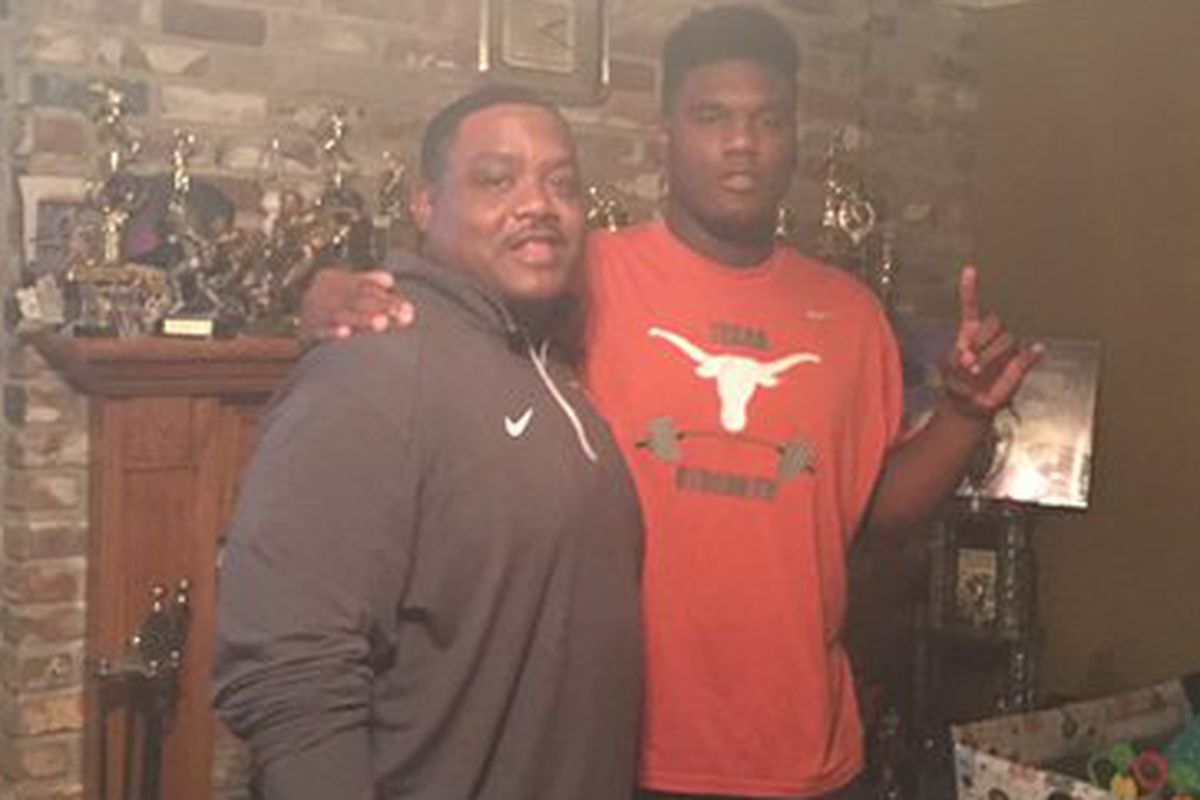 2016 DE commit Malcolm Roach posing with defensive line coach Brick Haley during an in-home visit.