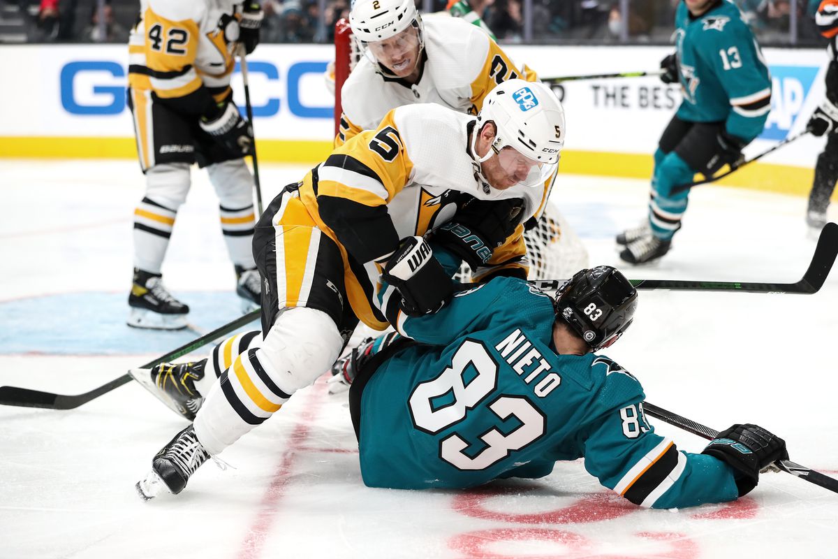 Matt Nieto #83 of the San Jose Sharks collides with Mike Matheson #5 of the Pittsburgh Penguins at SAP Center on January 15, 2022 in San Jose, California.
