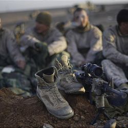 U.S. Marines wake up in the morning in their firing positions at a forward camp outside Marjah in Afghanistan's Helmand province on Friday.