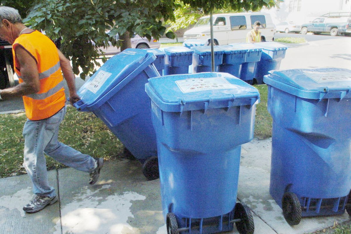 Chicago Streets and Sanitation workers put out recycling blue carts for Chicago’s recycling program in the 47th ward West Lakeview neighborhood in July 2007.