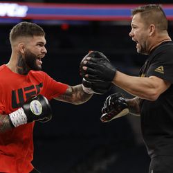 Cody Garbrandt hits pads at UFC 217 workouts.