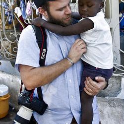 Deseret News photojournalist Mike Terry holds a child at the Maison des Enfants de Dieu in Haiti Jan. 26.