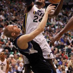 Paul Millsap of the Utah Jazz is fouled by Greg Stiemsma of the Minnesota Timberwolves during NBA basketball in Salt Lake City Friday, April 12, 2013.