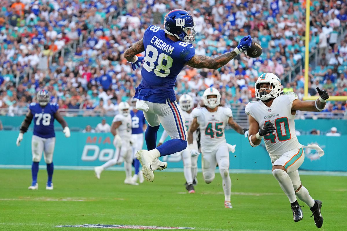 Evan Engram #88 of the New York Giants attempts to make a catch as Nik Needham #40 of the Miami Dolphins pursues the play during the third quarter at Hard Rock Stadium on December 05, 2021 in Miami Gardens, Florida.