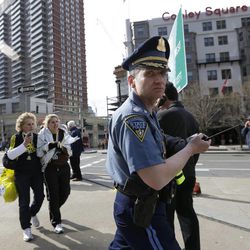 Boston police clear the area in Copley Plaza in the aftermath of two blasts which exploded near the finish line of the Boston Marathon in Boston, Monday, April 15, 2013.