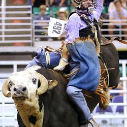Shawn Proctor rides G Force during the Days of 47 Rodeo Tuesday, July 22, 2014, at EnergySolutions Arena in Salt Lake City.