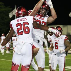 Utah’s Chase Hansen, right, celebrates after scoring a touchdown on a pick-six to seal the Utes’ win over Northern Illinois during the game Saturday, Sept. 8, 2018, at Huskie Stadium in DeKalb, Ill.