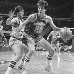 Brigham Young's Danny Ainge (22) drives past Notre Dame's John Paxson in the second half of action in Atlanta during the NCAA tournament, March 20, 1981.