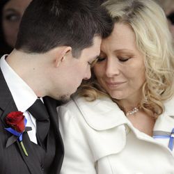 Nanette Wride and her son Shea Wride share a moment during the interment service for Utah County Sheriff's Sgt. Cory Wride at the Spanish Fork City Cemetery on Wednesday, Feb. 5, 2014.