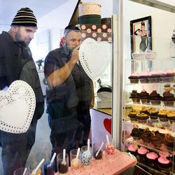 Steve Monroe, left, and Nate Purvis choose cupcakes at Mini's Gourmet Cupcakes in Salt Lake City on Friday, Feb. 6, 2015.  Purvis had driven past the cupcake shop frequently in the past, but was motivated to stop there today after hearing of the shop owner's heroic deeds. Shop owner Leslie Fiet rescued a kidnapped 3-year-old girl on Wednesday evening.
