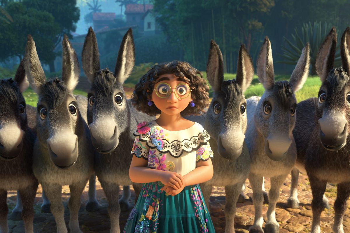 mirabel looking mildly confused in Encanto, flanked by a herd of donkeys