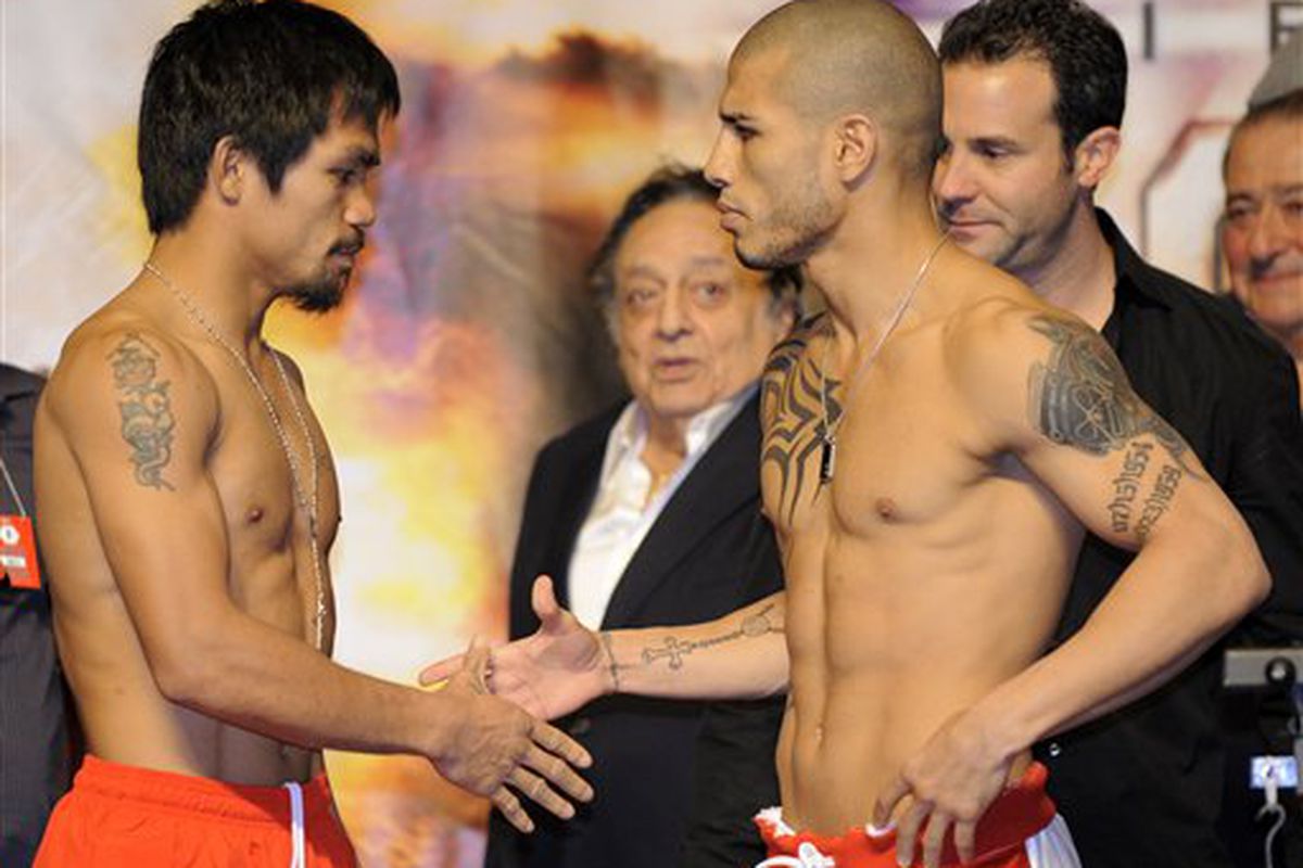 Manny Pacquiao and Miguel Cotto shake hands at their weigh-in on Friday. Those hands will be flying at the other man on Saturday in what could be the Fight of the Decade. (AP Photo/Mark J. Terrill)