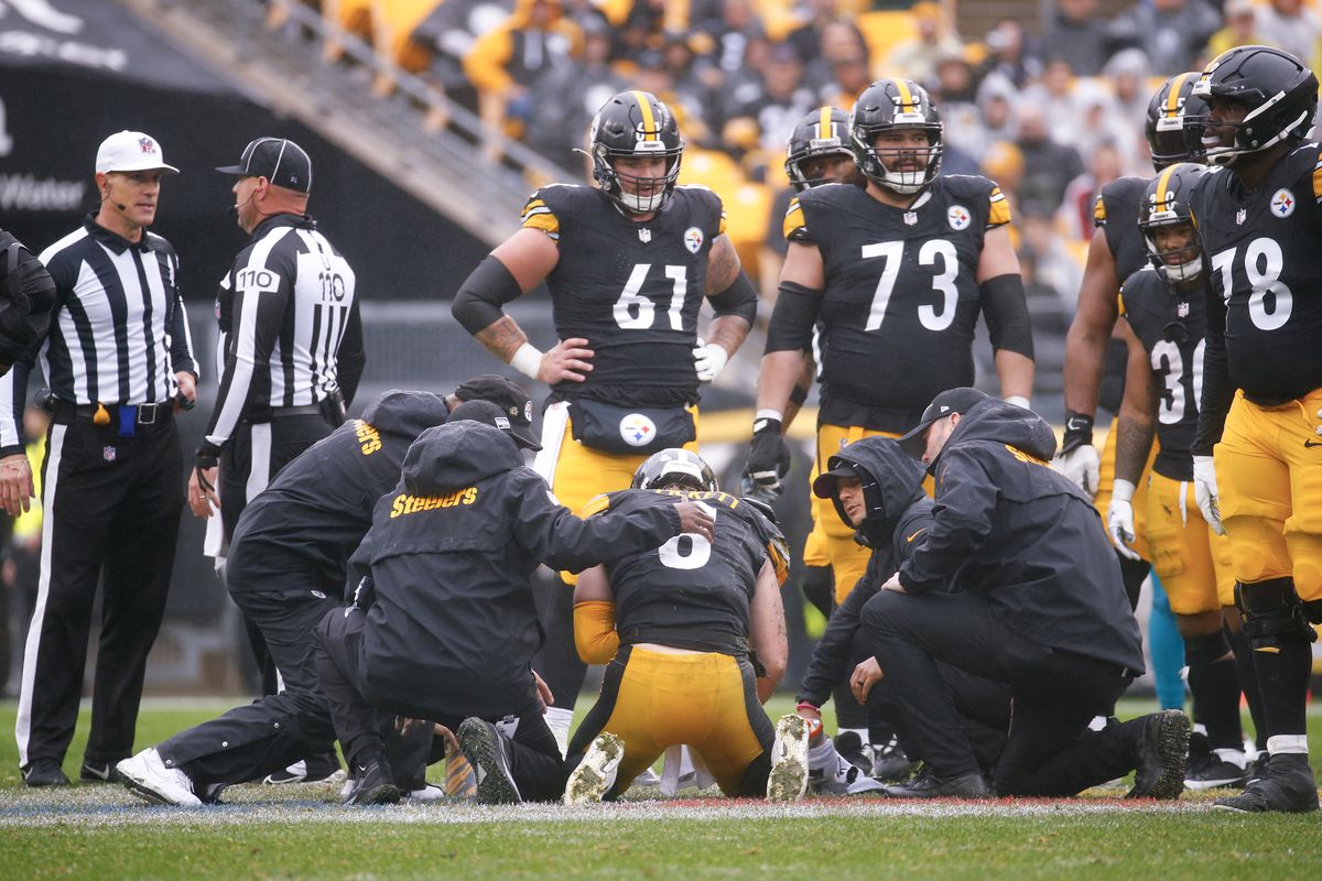 Pittsburgh Steelers team members look on as the training staff attends to Kenny Pickett #8 of the Pittsburgh Steelers after an injury during the second quarter of the game against the Jacksonville Jaguars at Acrisure Stadium on October 29, 2023 in Pittsburgh, Pennsylvania.