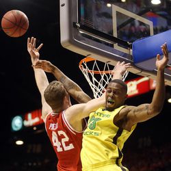 Oregon Ducks forward Elgin Cook (23) blocks a shot by Utah Utes forward Jakob Poeltl (42) during the first half of the Pac-12 Conference tournament championship game at the MGM Grand Garden Arena in Las Vegas Saturday, March 12, 2016.