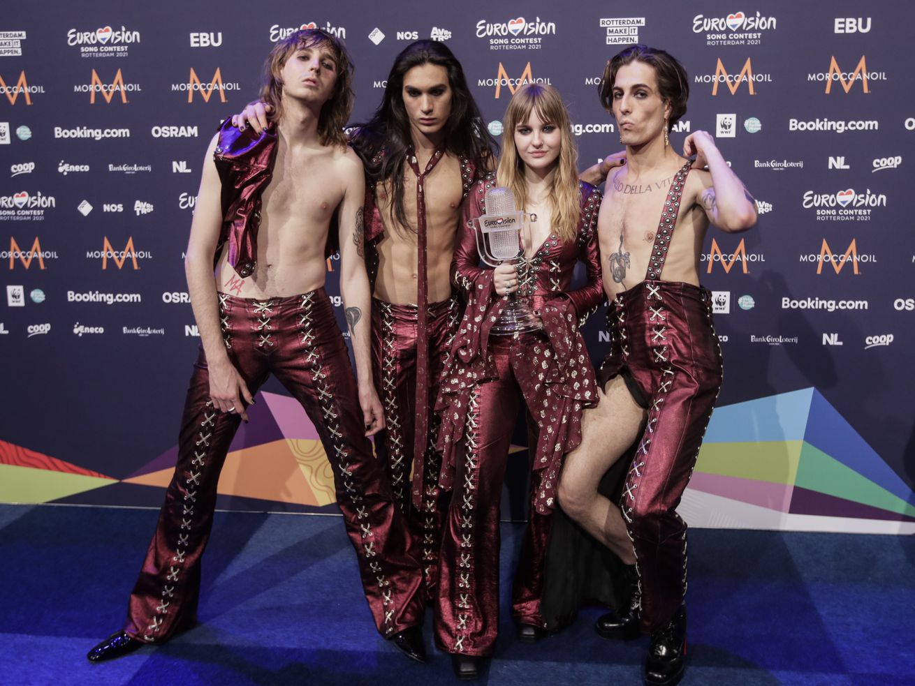 Maneskin — Thomas Raggi (from left), Ethan Torchio, Victoria De Angelis and Damiano David — pose for photographers with the trophy after winning the Grand Final of the Eurovision Song Contest at Ahoy arena in Rotterdam, Netherlands, on Saturday. 