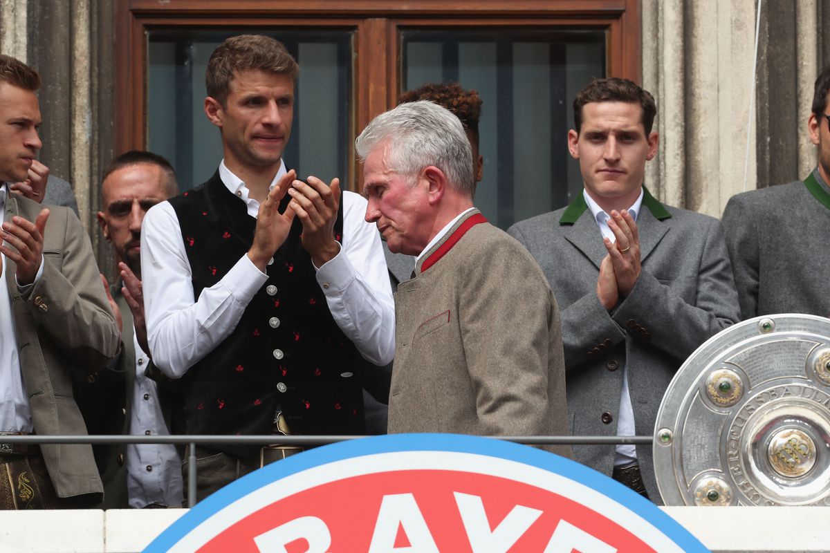 MUNICH, GERMANY - MAY 20: Team coach Jupp Heynckes (C) of FC Bayern Muenchen is pictured next to his players during the ceremony of winning the German Championship title for the season 2017/18 on the balcony of the town hall on May 20, 2018 in Munich, Germany.