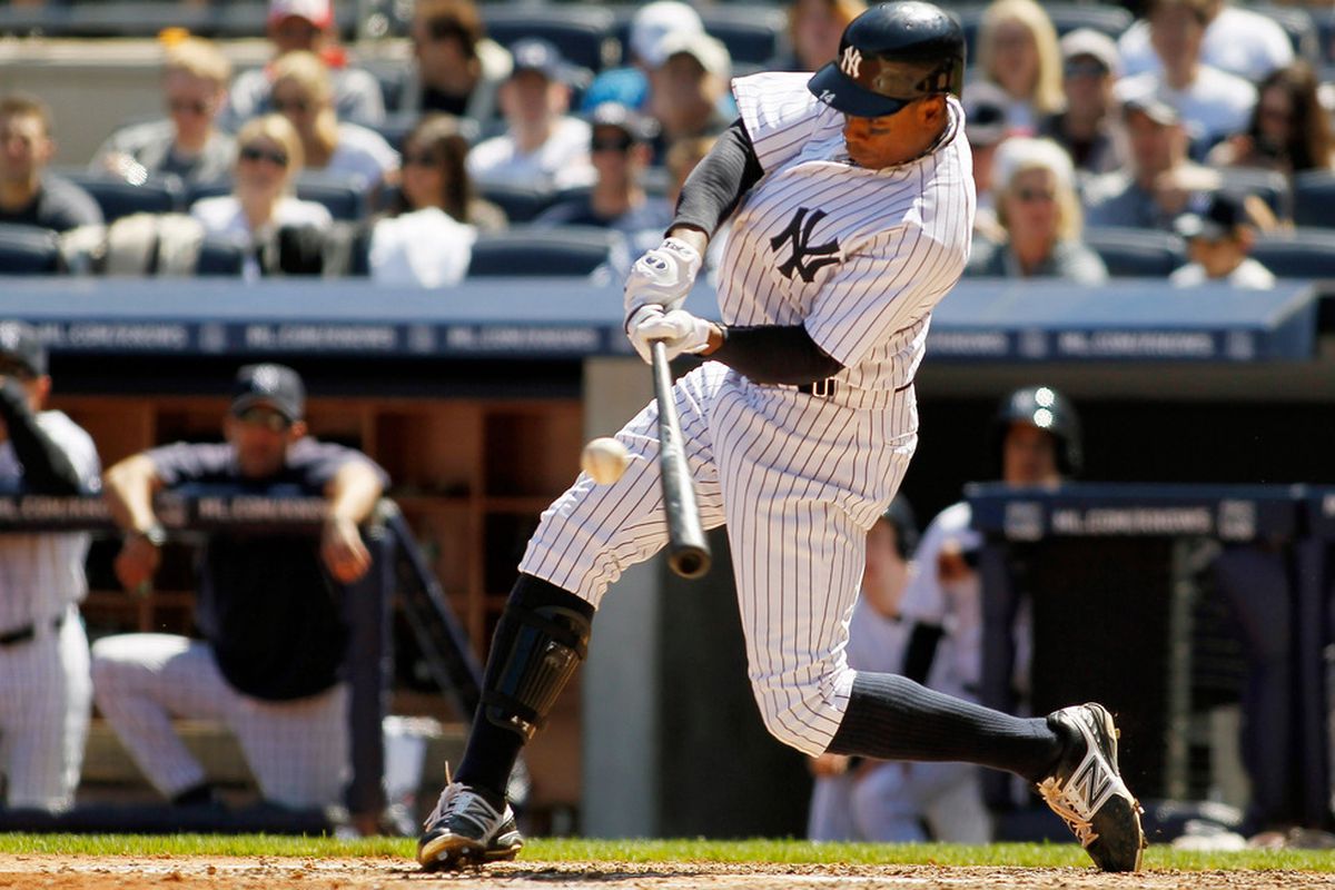 NEW YORK, NY - APRIL 29: Curtis Granderson #14 of the New York Yankees hits a solo home run in the fourth inning against the Detroit Tigers at Yankee Stadium on April 29, 2012 in the Bronx borough of New York City.  (Photo by Mike Stobe/Getty Images)