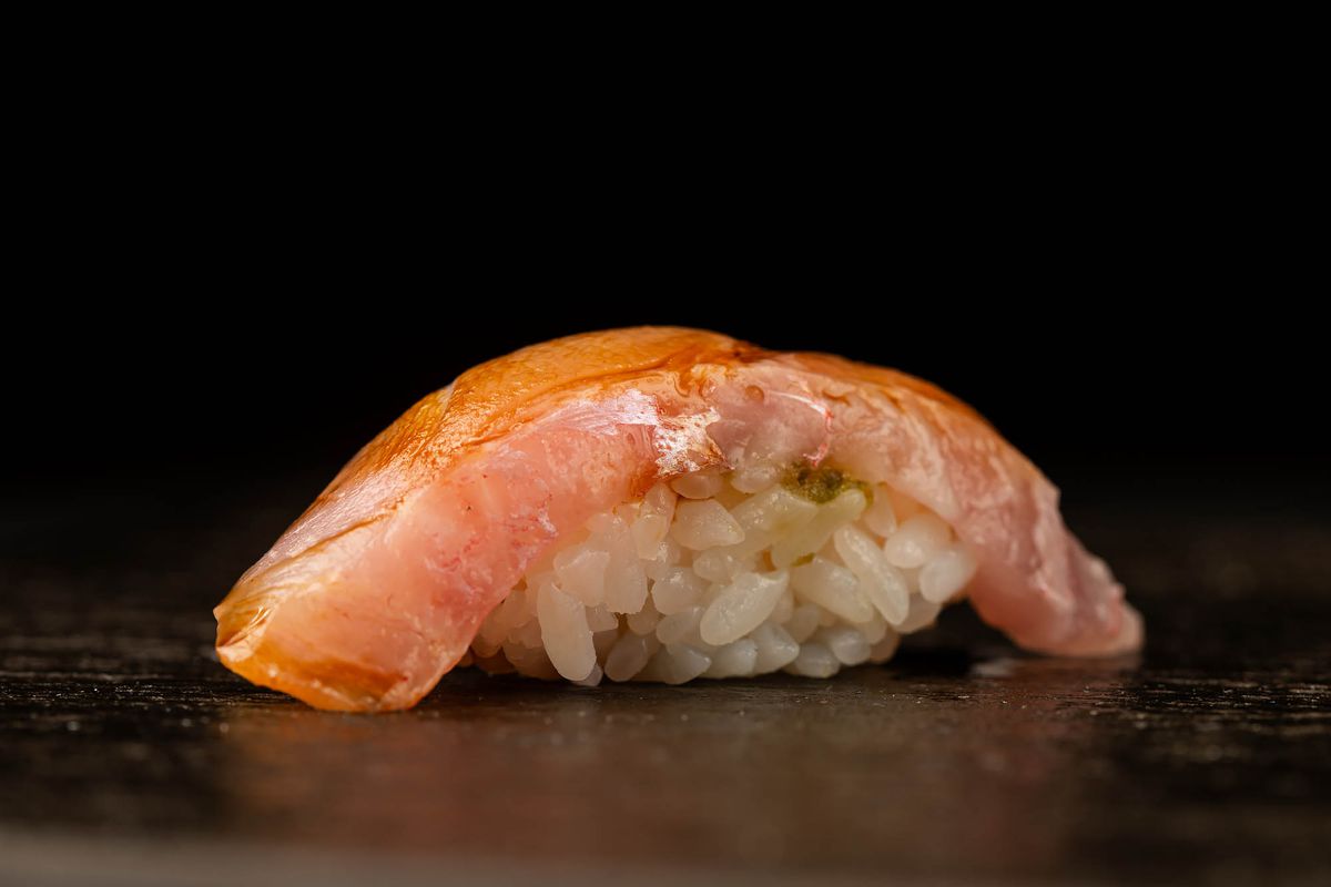 A nigiri course at Sushi Note on a black background.