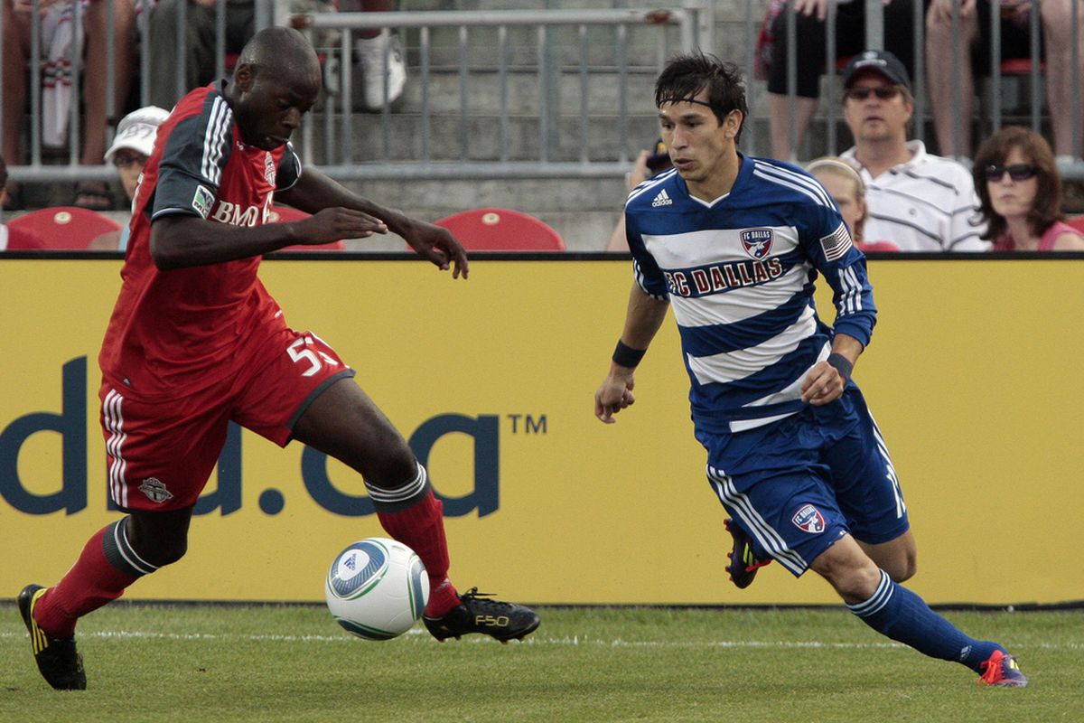 TORONTO, CANADA - JULY 20: Eddy Viator #55 of Toronto FC shoots past Eric Avila #12  of FC Dallas during MLS action at BMO Field July 20, 2011 in Toronto, Ontario, Canada. (Photo by Abelimages/Getty Images)