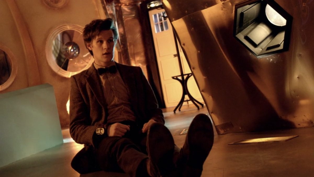 The Doctor sitting up on the floor of the Tardis