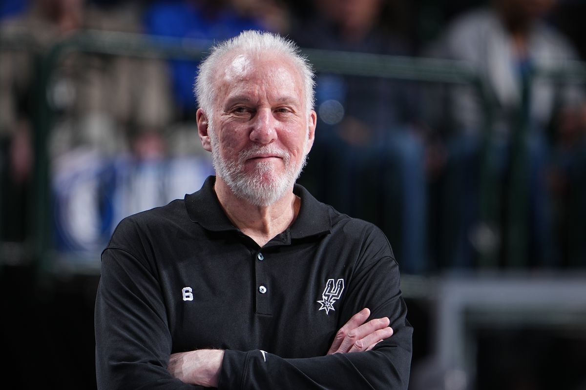 Gregg Popovich smiles during a game.