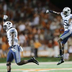 BYU players celebrate a fumble recovery as BYU and Texas play Saturday, Sept. 6, 2014, in Austin Texas. BYU won 41-7.