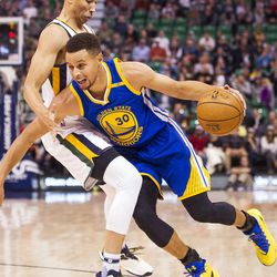 Golden State guard Stephen Curry (30) tries to get around Utah guard Dante Exum (11) during the second half of an NBA basketball game in Salt Lake City on Thursday, Dec. 8, 2016. Golden State defeated Utah with a final score of 106-99.