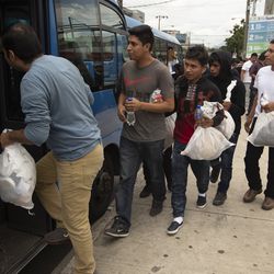 Guatemalan men who were deported from the United States, board a bus after arriving at the Air Force Base in Guatemala City, Tuesday, July 16, 2019. Nearly 200 Guatemalan migrants have been deported on Tuesday, the day the Trump administration planned to launch a drastic policy change designed to end asylum protections for most migrants who travel through another country to reach the United States. (AP Photo/Moises Castillo)
