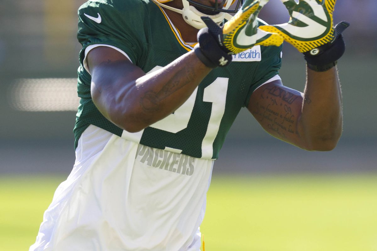 July 28, 2012; Green Bay, WI, USA; Green Bay Packers cornerback Charles Woodson (21) prepares to catch a pass during training camp practice at Ray Nitschke Field. Mandatory Credit: Jeff Hanisch-US PRESSWIRE