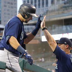 DETROIT, MI - AUGUST 30: Cal Raleigh #29 of the Seattle Mariners receives a high-five from manager Scott Servais #9 after hitting a solo home run against the Detroit Tigers during the third inning at Comerica Park on August 30, 2022, in Detroit, Michigan.