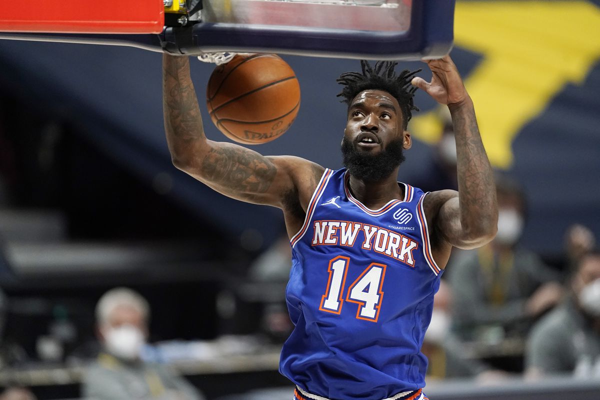 New York Knicks forward Norvel Pelle dunks the ball during game against the Nuggets Wednesday, May 5, 2021, in Denver.
