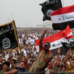 FILE -- Sunni protesters wave Islamist flags while others chant slogans at an anti-government rally in Fallujah, Iraq, Friday, May 3, 2013. The leader of al-Qaida's Iraq arm, Abu Bakr al-Baghdadi, defiantly rejected an order from the terror network's global command to scrap a merger with the organization's Syria affiliate, according to a message purporting to be from Al-Baghdadi that was posted online Saturday, June 15, 2013. 