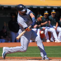 Sep 22, 2022; Oakland, California, USA; Seattle Mariners right fielder Mitch Haniger (17) hits an RBI single against the Oakland Athletics during the first inning at RingCentral Coliseum. Mandatory Credit: Kelley L Cox