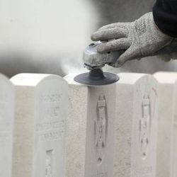 A worker for the Commonwealth War Graves Commission sands down headstones of WWI soldiers at Tyne Cot cemetery in Zonnebeke, Belgium on Monday, April 15, 2013. With nearly 12,000 graves the cemetery is the largest Commonwealth war cemetery in the world in terms of burials. Commonwealth cemeteries and monuments around the world are currently being renovated in preparation for centenary events which begin in 2014. 