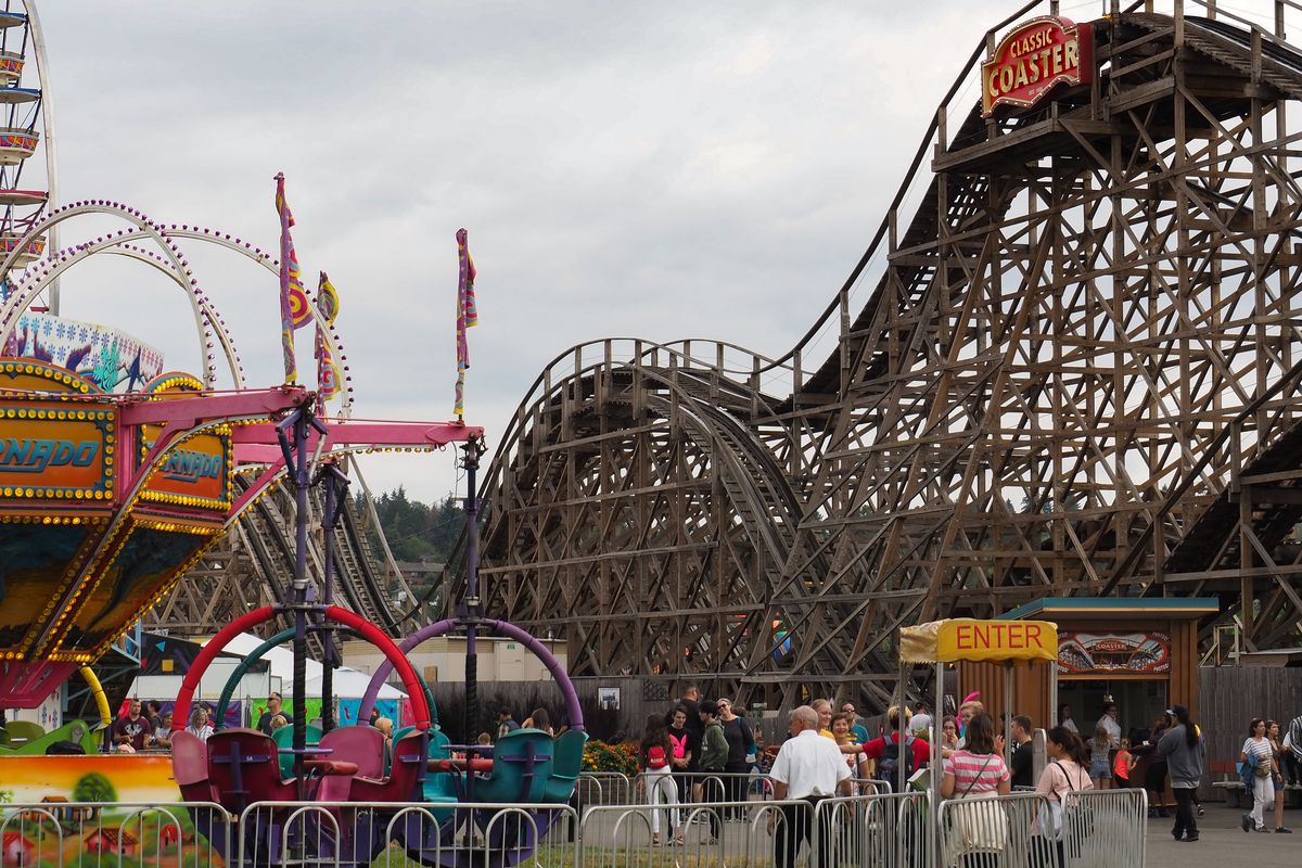 A roller coaster on a cloudy day at the Washington State Fair in Puyallup.