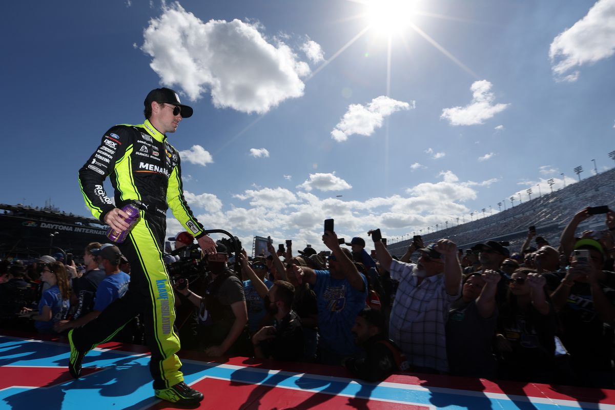 Ryan Blaney, driver of the #12 Menards/Blue DEF/PEAK Ford, greets fans onstage during the driver intros prior to the NASCAR Cup Series 64th Annual Daytona 500 at Daytona International Speedway on February 20, 2022 in Daytona Beach, Florida.