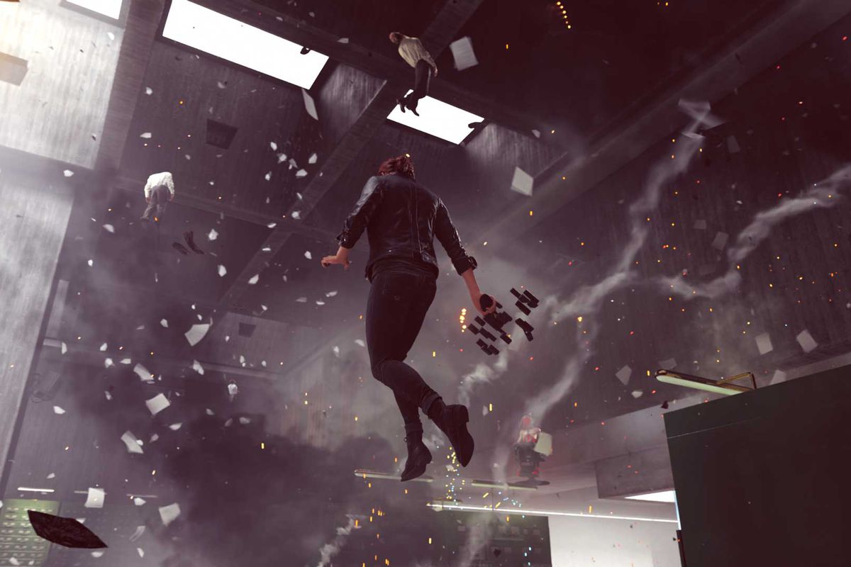 a woman floats in an office, with debris flying everywhere around her
