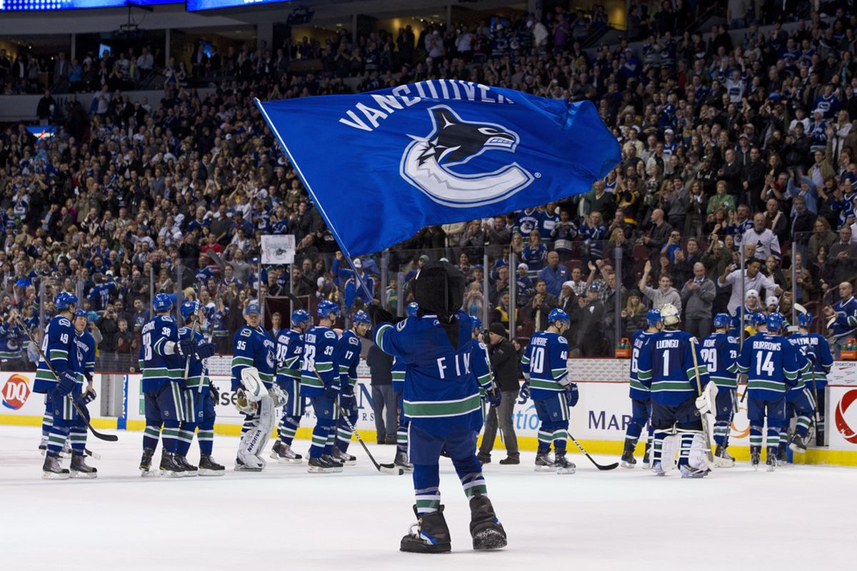 VANCOUVER, CANADA - MARCH 31: Vancouver Canucks mascot Fin waves a team flag after the Vancouver Canucks defeated the Los Angeles Kings in NHL action on March 31, 2011 at Rogers Arena in Vancouver, BC, Canada.  (Photo by Rich Lam/Getty Images)