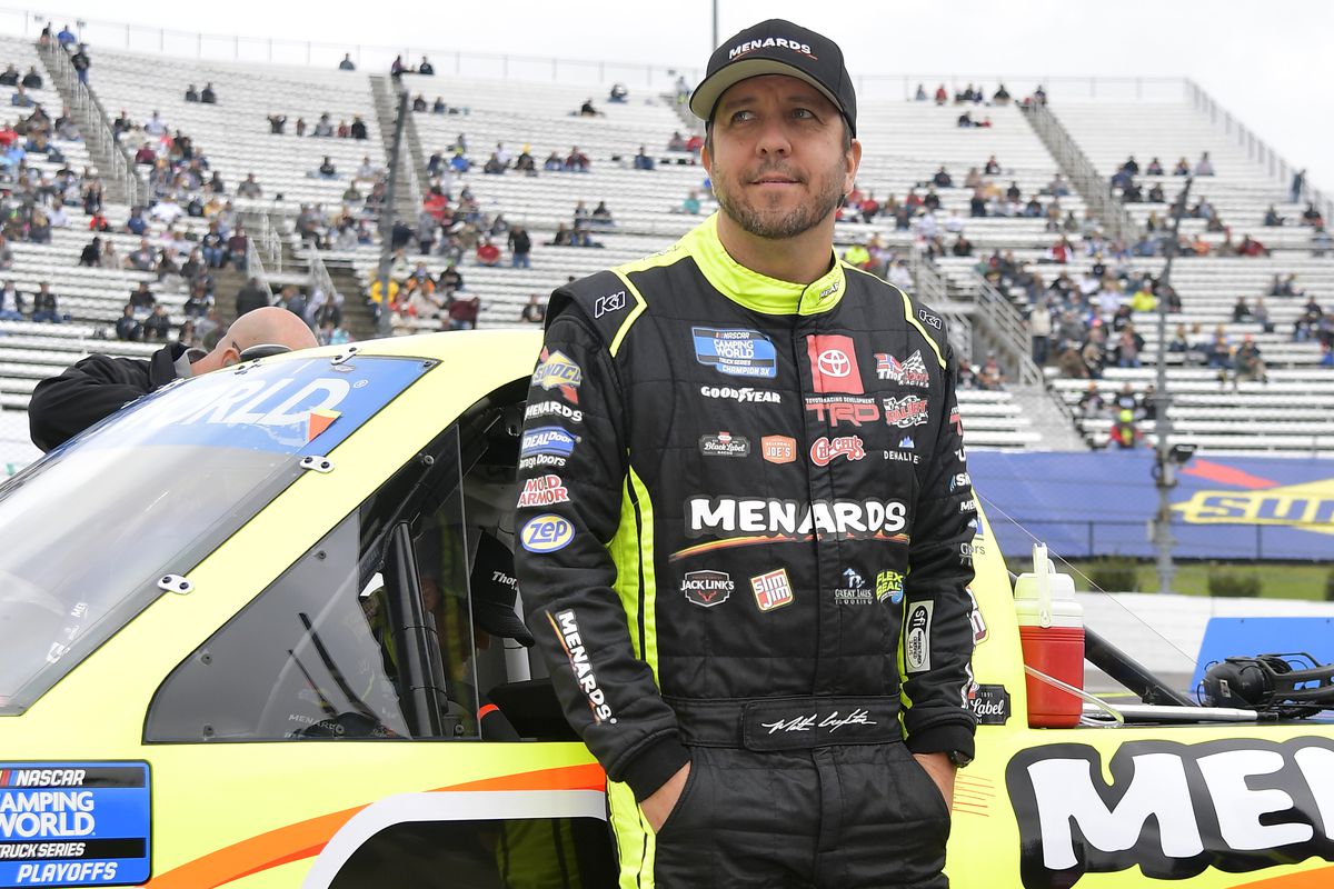 Matt Crafton, driver of the #88 Black Label Bacon/Menards Toyota, waits on the grid prior to the NASCAR Camping World Truck Series United Rentals 200 at Martinsville Speedway on October 30, 2021 in Martinsville, Virginia.