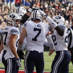 Brigham Young quarterback Taysom Hill (7) is congratulated by teammates after scoring a touchdown against Cincinnati during the first half of an NCAA college football game, Saturday, Nov. 5, 2016, in Cincinnati. (AP Photo/Gary Landers)