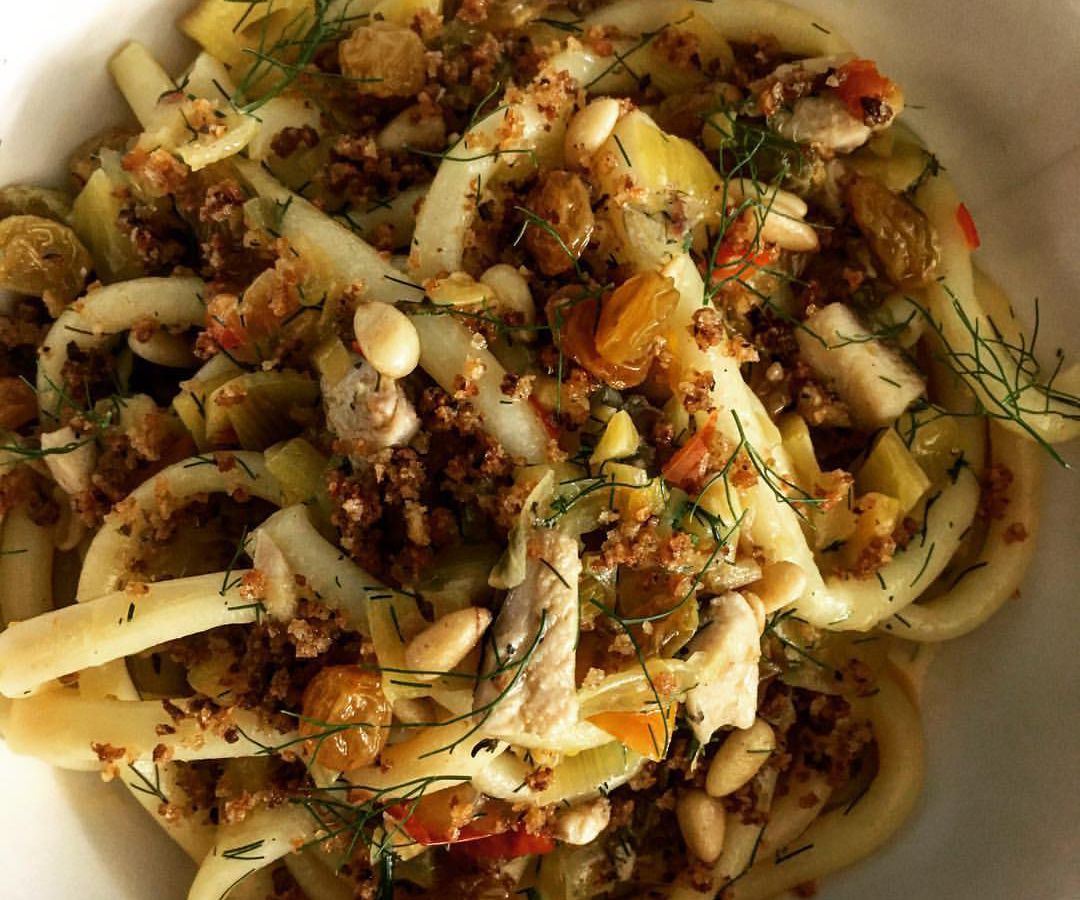 A plate of round, long pasta with spices.