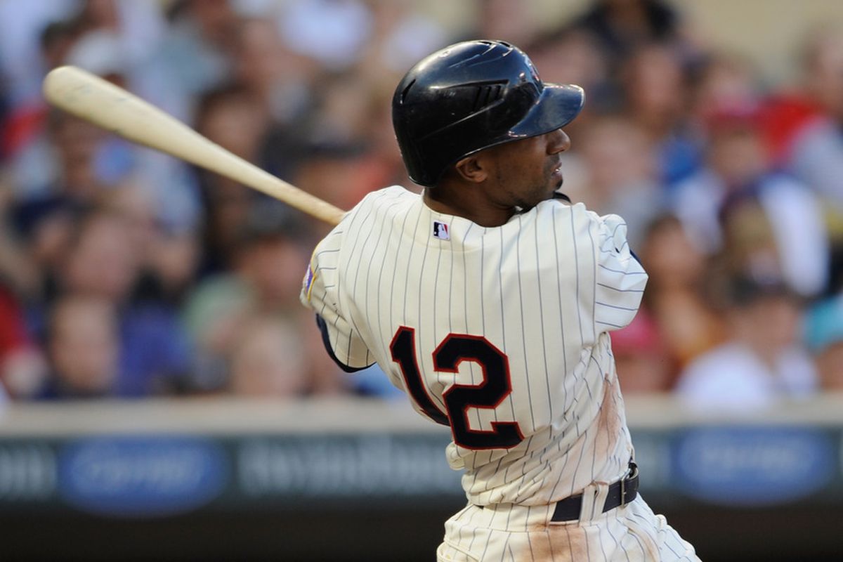 MINNEAPOLIS, MN - JUNE 28: Alexi Casilla #12 of the Minnesota Twins hits an RBI double against the Los Angeles Dodgers in the second inning on June 28, 2011 at Target Field in Minneapolis, Minnesota. (Photo by Hannah Foslien/Getty Images)