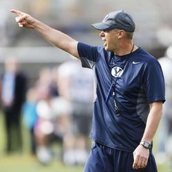Brigham Young Cougars head coach Bronco Mendenhall  shouts instruction during a scrimmage in Provo  Friday, April 4, 2014. BYU alumni attended the scrimmage. 