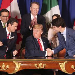 President Donald Trump, center, shakes hands with Canada's Prime Minister Justin Trudeau as Mexico's President Enrique Pena Nieto looks on after they signed a new United States-Mexico-Canada Agreement that is replacing the NAFTA trade deal, during a ceremony at a hotel before the start of the G20 summit in Buenos Aires, Argentina, Friday, Nov. 30, 2018. The USMCA, as Trump refers to it, must still be approved by lawmakers in all three countries. (AP Photo/Martin Mejia)