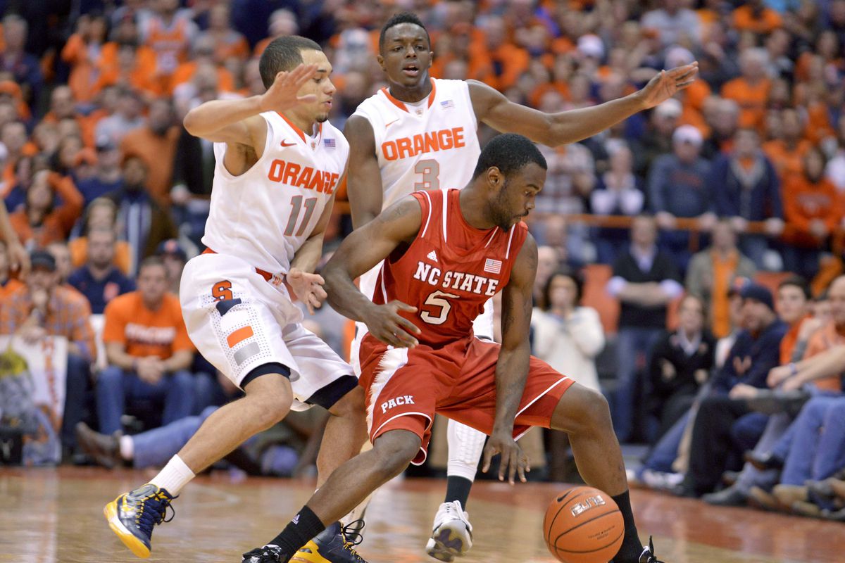 Syracuse Orange guard Tyler Ennis (11) and forward Jerami Grant (3) force North Carolina State Wolfpack guard Desmond Lee (5) to commit a turnover late in the second half of a game at the Carrier Dome. Syracuse won the game 56-55