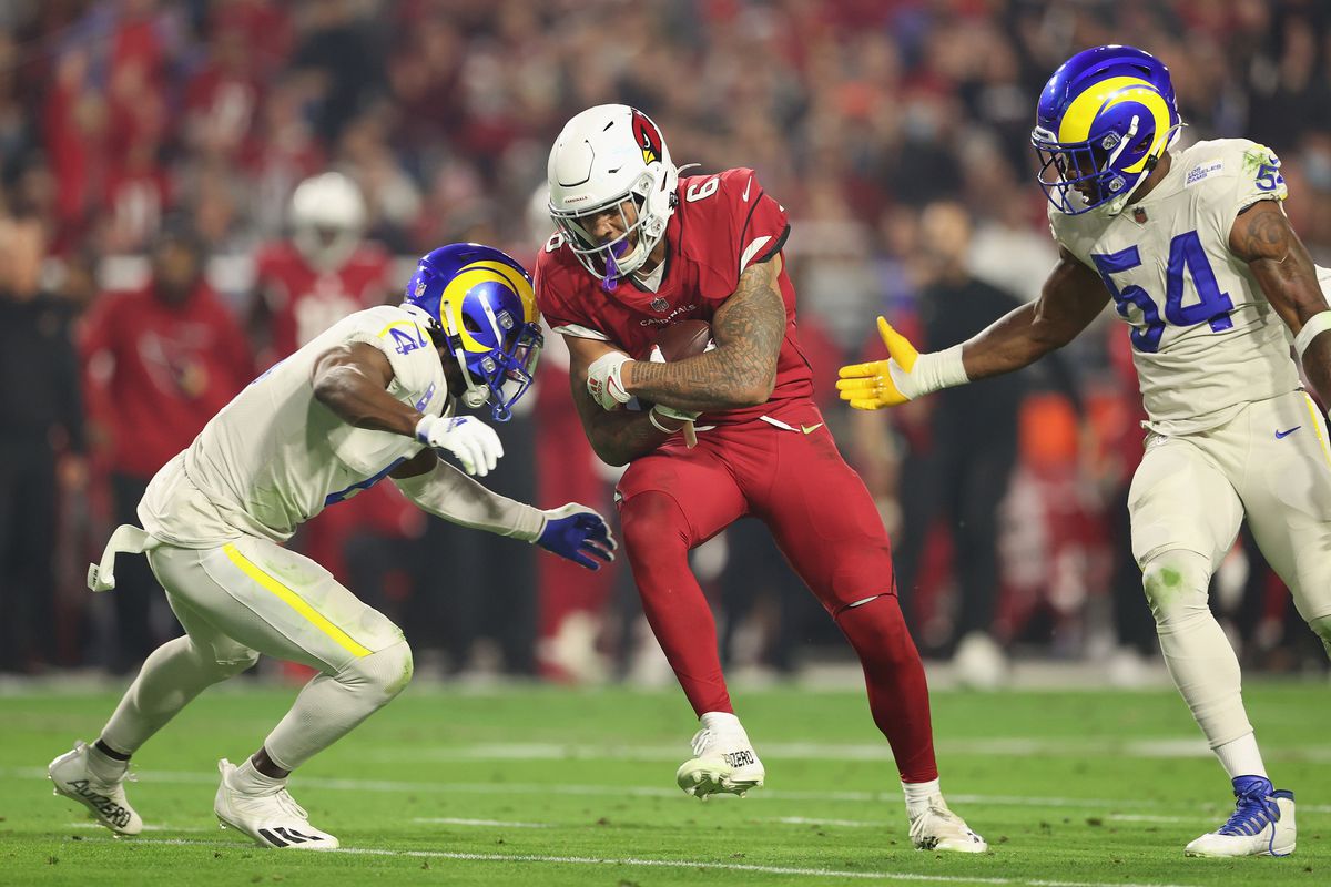 Running back James Conner #6 of the Arizona Cardinals rushes the football against the Los Angeles Rams during the NFL game at State Farm Stadium on December 13, 2021 in Glendale, Arizona.