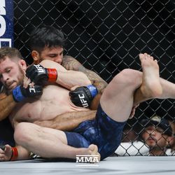 Dustin Ortiz tries to avoid submission at UFC 220.<br>