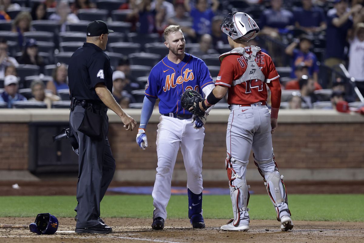 Pete Alonso of the New York Mets has words with Logan O’Hoppe of the Los Angeles Angels after he was hit by a pitch in the eighth inning at Citi Field on August 26, 2023 in New York City.