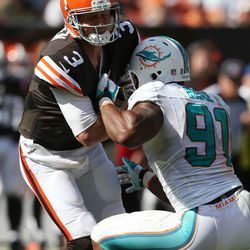 Sep 8, 2013; Cleveland, OH, USA; Miami Dolphins defensive end Cameron Wake (91) sacks Cleveland Browns quarterback Brandon Weeden (3) during the fourth quarter at FirstEnergy Field. The Dolphins won 23-10.